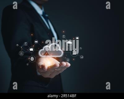 Businessman holding cloud icon. Cloud computing concept, connect communication equipment  information and technology with cloud computing. Stock Photo
