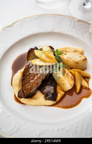 Roasted venison with celeriac and mashed potatoes Stock Photo
