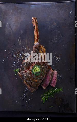 Grilled tomahawk steak with herb butter Stock Photo