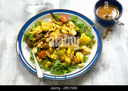 Cabbage salad with cauliflower, Brussels sprouts, rocket and turmeric Stock Photo