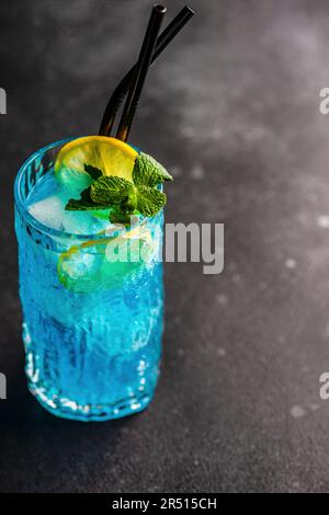 Cocktail high glass with blue kamikaze drink decorated with fresh mint ...