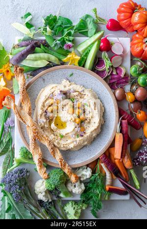 Hummus with fresh vegetables Stock Photo