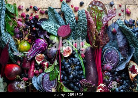 Autumn still life with vegetables and fruit in purple Stock Photo