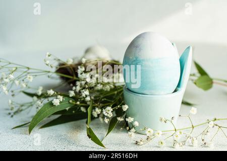 Blue coloured egg in an Easter egg cup Stock Photo