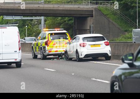 Breakdown in outside lane of M1 smart motorway.  Broken down car with Traffic Officer vehicle in attendance with tow rope - England, UK Stock Photo