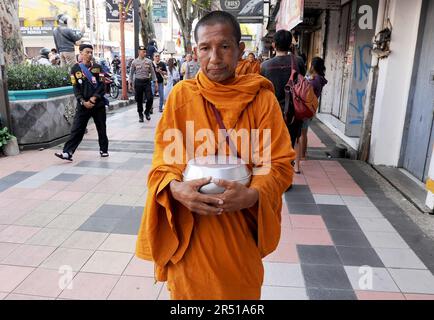 May 31, 2023, Magelang, Central Java, Indonesia: Monks from Thailand, Singapore, Malaysia, Indonesia who perform the Thudong ritual on foot to Borobudur Temple, go for alms at the Liong Hok Bio Temple in Magelang, Central Java, on May 31 2023. In Magelang City, the monks received a friendly welcome from the locals. around waiting on the side of the road for the Pindapata tradition which was stopped for 3 years, Pindapata is a Buddhist tradition of giving alms to monks or priests in the form of food, money, and various daily needs. The 32 monks are scheduled to continue their final journey to B Stock Photo