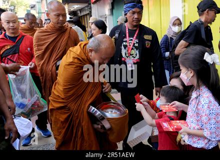 May 31, 2023, Magelang, Central Java, Indonesia: Monks from Thailand, Singapore, Malaysia, Indonesia who perform the Thudong ritual on foot to Borobudur Temple, go for alms at the Liong Hok Bio Temple in Magelang, Central Java, on May 31 2023. In Magelang City, the monks received a friendly welcome from the locals. around waiting on the side of the road for the Pindapata tradition which was stopped for 3 years, Pindapata is a Buddhist tradition of giving alms to monks or priests in the form of food, money, and various daily needs. The 32 monks are scheduled to continue their final journey to B Stock Photo