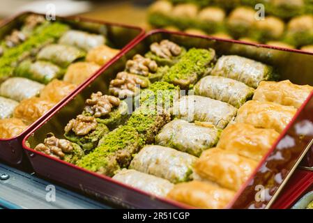 Traditional Turkish Baklava on display in dessert store. Turkish baklava on tray. Traditional Baklava from Istanbul, Turkey. Baklava with pistachio. Stock Photo