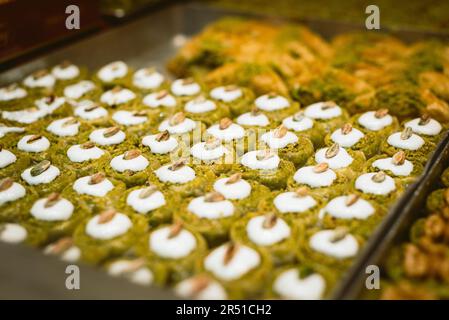 Traditional Turkish Baklava on display in dessert store. Turkish baklava on tray. Traditional Baklava from Istanbul, Turkey. Baklava with pistachio. Stock Photo