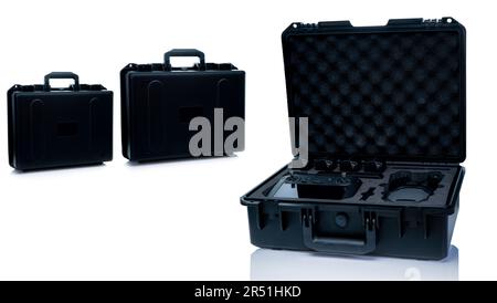 Drone and accessories in plastic case isolated on white background. UAV or unmanned aerial vehicle and drone accessories in protective travel case. Stock Photo