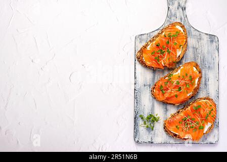 Blank food photography of toast with smoked salmon, cream cheese, cress salad, breakfast, sandwich, bruschetta, fillet, slice, seafood Stock Photo