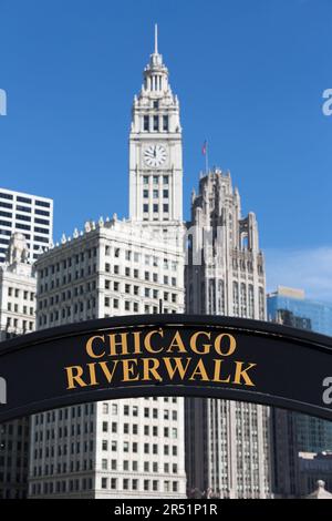 USA, Illinois, Chicago, the Wrigley Building clock tower and Chicago Riverwalk sign. Stock Photo