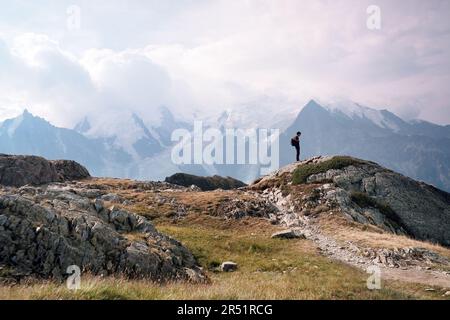 Scenic view of Mont Blanc massif seen from Le Brevent, Aiguille Rouges, Tour de Mont Blanc, Chamonix, French Alps, Haute Savoie. Hiker on the route.. Stock Photo