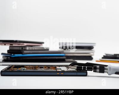Cell phone parts and tools, phone repair, smartphone and mobile technology upgrades. The concept of repair and diagnostics of smartphones. Stock Photo