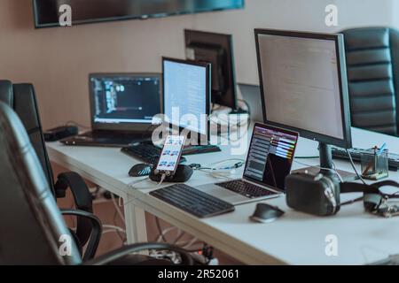 Computer screens running programming code in empty software developing agency office and computers parsing data algorithms in background. Neural Stock Photo