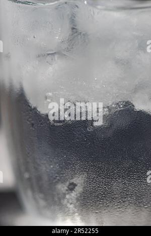 Close up of glass of pure water with ice cubes in hot summer day Stock Photo