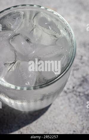 From above glass of pure water with ice cubes in hot summer day Stock Photo