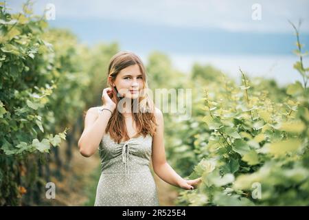 Outdoor portrait of pretty young teenager girl hiking in vineyards, summer activities Stock Photo