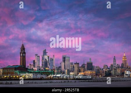 Winter Sunset NYC Skyline - The winter skyline of New York City is particularly stunning.   The sunsets are especially beautiful in the winter, as the Stock Photo
