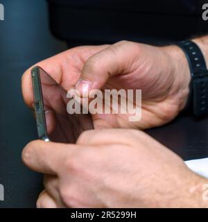 A smartphone in the hands of a man Stock Photo