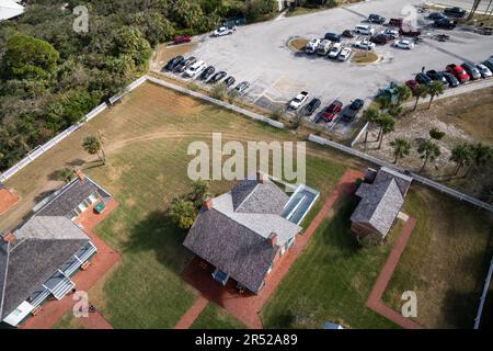 Ponce Inlet, Florida - December 29, 2022: Aerial view looking down on the various buildings surrounding the Ponce Inlet Lighthouse and parking lot Stock Photo