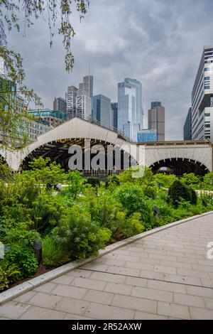 The arched roof of Liverpool Street Station from the gardens in The Broardgate Arena Stock Photo