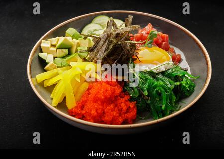 seaweed-infused pibimpap with flying fish roe, meat, fish, and nori Stock Photo