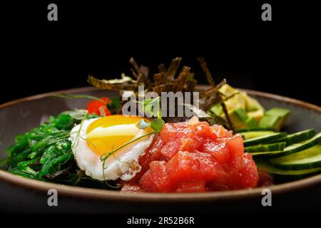 seaweed-infused pibimpap with flying fish roe, meat, fish, and nori Stock Photo