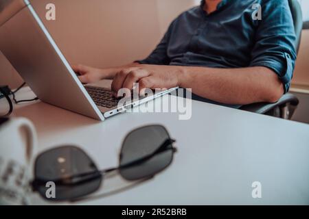 Close-up photo of a programmer typing on a laptop Stock Photo