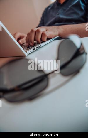 Close-up photo of a programmer typing on a laptop Stock Photo