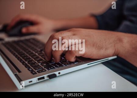 Close-up photo of a programmer typing on a laptop Stock Photo