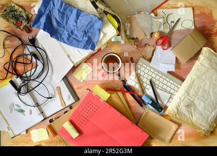 messy and clutterd office workplace, overworked, red tape, bureaucracy, business concept, flat lay with various office supplies Stock Photo