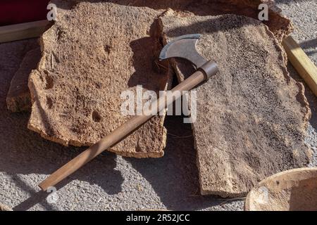 Antique axe to cut the bark of the cork oak to extract the cork Stock Photo