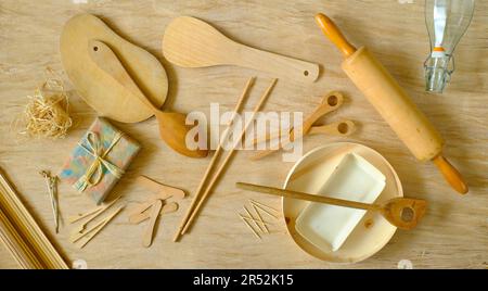 kitchen utensils from eco friendly materials on tablecloth made of compressed tree bark, recycling, environmental conservation concept, flat lay Stock Photo