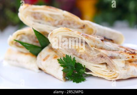 Roasted pancake with meat and greens (closeup) (selective focus) Stock Photo