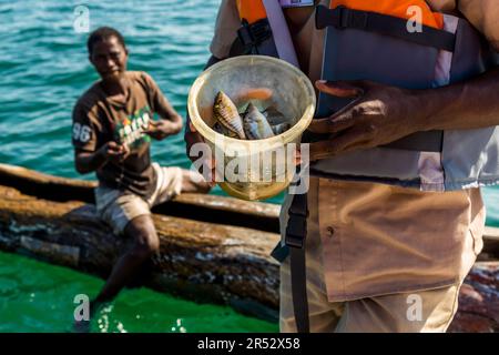 A fisherman sells his catch directly from the boat. Lake Malawi, Cape Maclear. In Lake Malawi there are 350 endemic species of cichlids Stock Photo