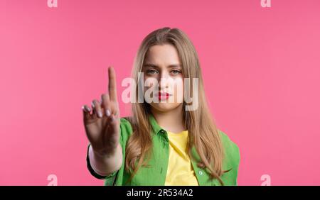 Uninterested woman disapproving with NO finger sign gesture. Attention. Stock Photo