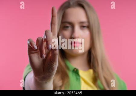 Uninterested woman disapproving with NO finger sign gesture. Attention. Stock Photo