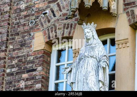 Figure of the Virgin Mary in front of the cloister in Peppange Luxembourg Stock Photo