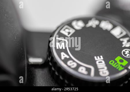 A DSLR camera dial showing Manual mode engaged against a white background Stock Photo