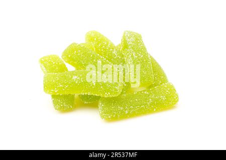 Pile of green sugary jelly candies isolated on white background. Gummy worms treat Stock Photo