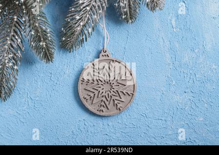 Concrete Christmas ball on blue textured gypsum. Joinery tradition. New Year's background for building store. Building Material Used in Construction. Stock Photo