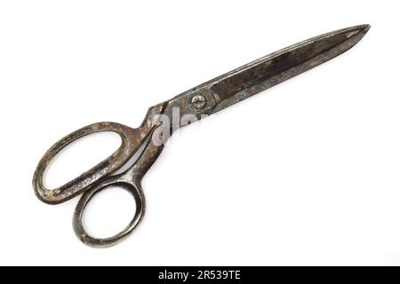Old and rusty retro dressmaking scissors isoilated on white background. Traditional fashion equipment Stock Photo
