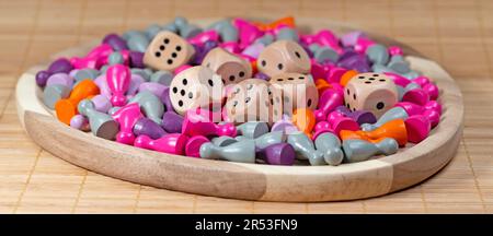 Many colorful game pieces and dice for board games Stock Photo