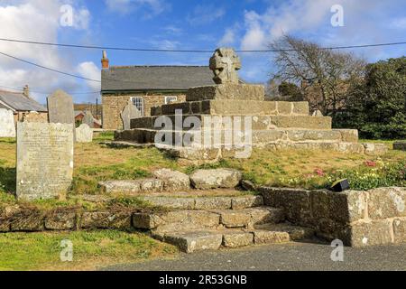 An old stone cross in the grave yard or cemetery of the parish Church of St Buryan, St Buryan, Cornwall, England, UK Stock Photo