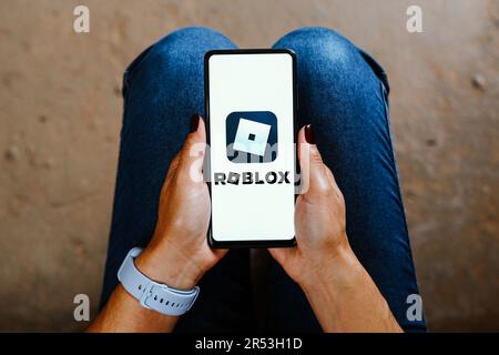 In this photo illustration, the Roblox logo is displayed on a smartphone screen. Stock Photo