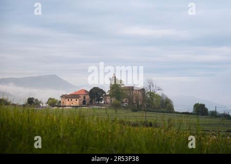 Landscape of the small town of Lezama with its bell tower, in the rural and green surroundings of Amurrio in the Ayala or Aiaraldea valley Stock Photo