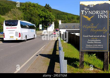 Clear blue skies and bright sunshine at Tyndrum, cars on the A82 road Tyndrum, Scotland Stock Photo