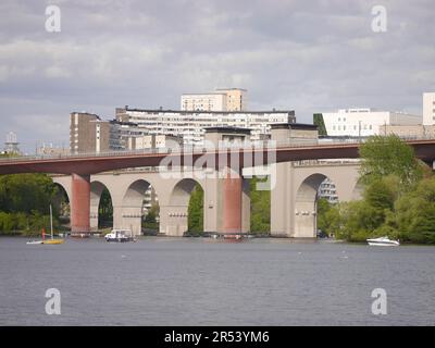 View of bridge over river against cloudy sky Stock Photo