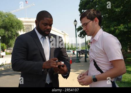 Washington, DC, USA. 31 May 2023. Before arriving at the U.S. Capitol for a procedural vote, U.S. Rep. Byron Donalds (R-Fla.) signs a trading card. Credit: Philip Yabut/Alamy Live News Stock Photo
